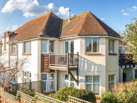 The exterior of a two story house with a balcony and tiled roof at Bayview Overcombe near Preston
