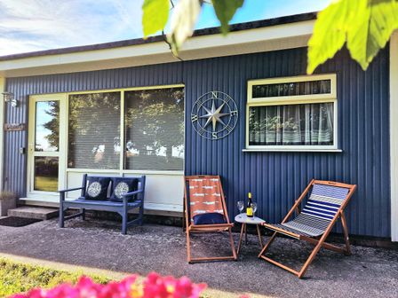 An outdoor seating area with chairs and a table at Driftwood in Dartmouth