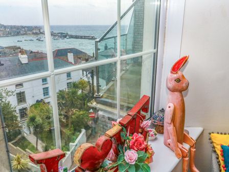A living room with a view of the ocean at Harbour View in St Ives