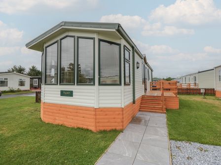 A mobile home with a deck and steps at Birch in Denny