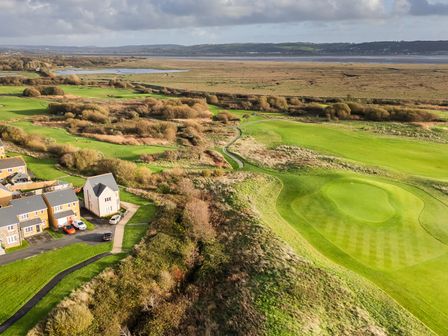 An aerial view of a golf course and residential area at 69 Ffordd Y Meillion Llanelli