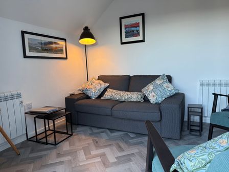 A living room with a sofa and lamp at Claife Flights Bowness-On-Windermere