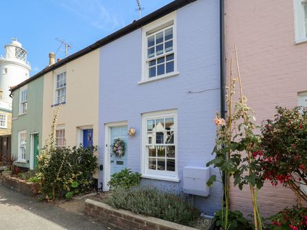 A row of colored houses with flower beds at Victoria Cottage (4 East Green) Southwold
