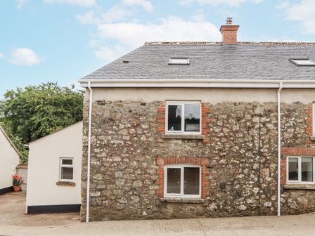A stone building with windows at Aunty Junes Cottage in Okehampton