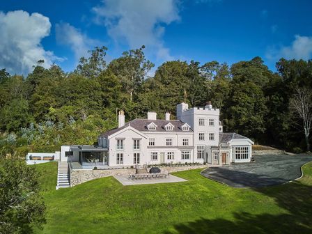 A large house with a terrace and garden at Craig y Don in Glyngarth near Llandegfan