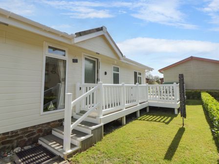 An outdoor area with a white deck and steps at Erisa in Stepaside