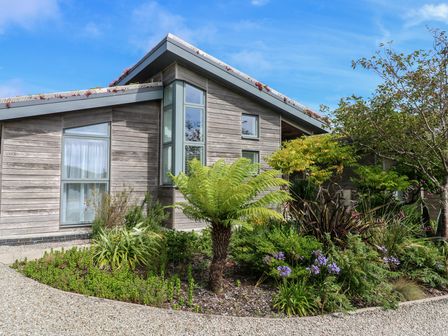 A house with large windows and a garden at Una, Lodge 70 Carbis Bay