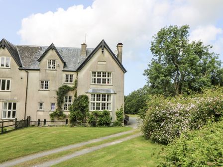 A house with windows and a pathway at Plas Pontfaen near Fishguard and Newport, Pembrokeshire