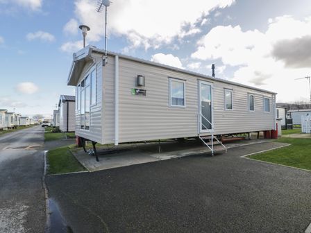 A mobile home with steps and windows at Lido Gold 273 in Prestatyn