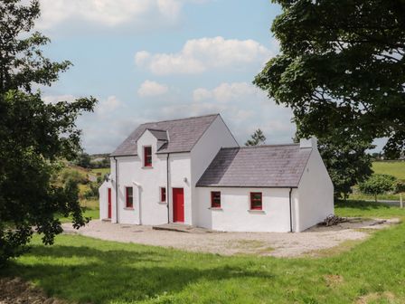 A house with red accents and a gravel area at Shane's Cottage, Falcarragh, County Donegal