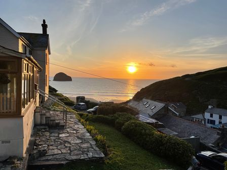 A view of a sunset over the water at Sea Ledge Trebarwith Strand near Tintagel