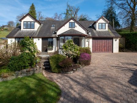 A house with a garage and garden at Marina View Bowness-On-Windermere