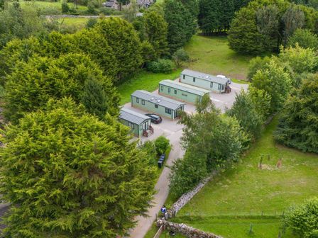 An outdoor area with cabins and trees at Lodge 4 in Silverdale