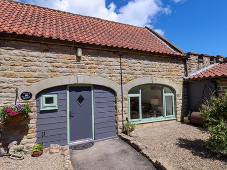 The entrance of a cottage with a doorway and a window at Wayside Farm Stable Cottage Cloughton near Burniston