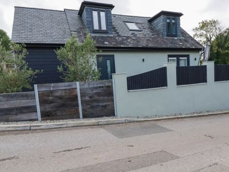 A house with a sloped roof and windows at Tiddlywink near Indian Queens