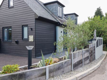 A house with a fence and plants at Tiddlywink near Indian Queens