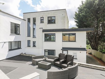 An outdoor area with seating and a table at Treliance in Truro
