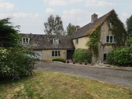 A house with a driveway and plants at St. Marys House Church Westcote near Bledington