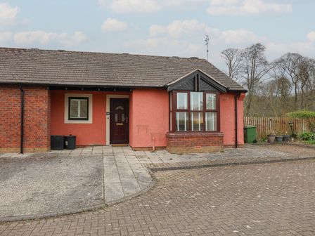 A bungalow entrance with a front door and windows at Bungalow 19 Eamont Park in Penrith