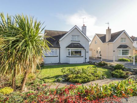 A front view of two detached houses with gardens in front at Seabreeze in Llandudno
