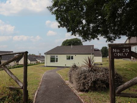 A bungalow with pathway and sign at Harcombe House Bungalow 25 Chudleigh