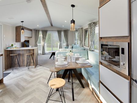 A living room with a table set for dining at Island Breeze - Hayling Island