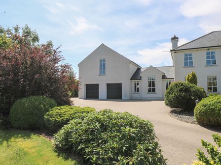 A house with a garage and garden at The East Wing Apartment in Claremorris