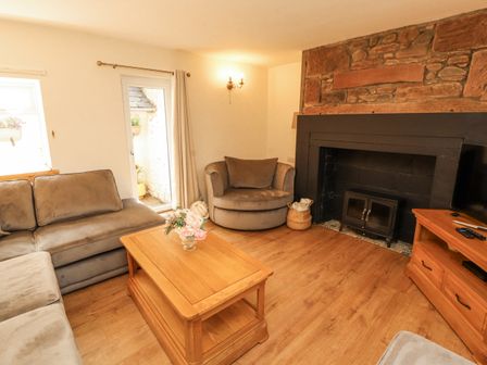 A living room with a sofa and coffee table at Sun House in Allonby