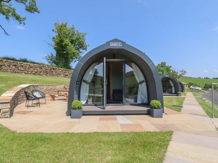 An outdoor area with a pod and seating at Ogden in Nelson
