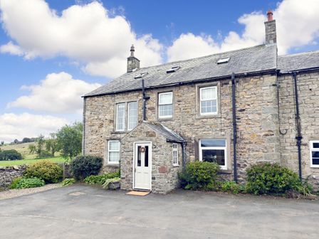 A house with stone exterior and garden at Bush Nook House in Brampton, Cumbria