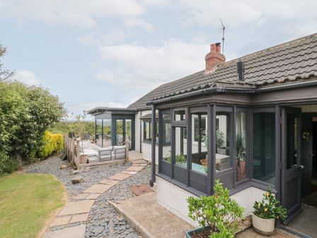 A house exterior with garden and pathway at Sea Haven Hunmanby Gap near Primrose Valley
