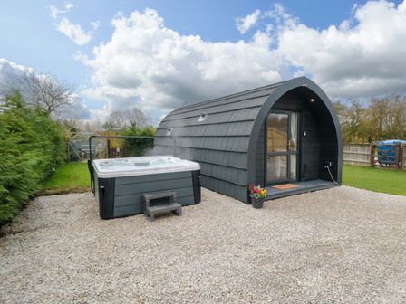 An outdoor area with a hot tub next to a glamping pod at Bumblebee Glamping Pod in Malton