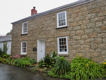 A stone cottage with plants in front at 1 Rowes Cottages Penzance
