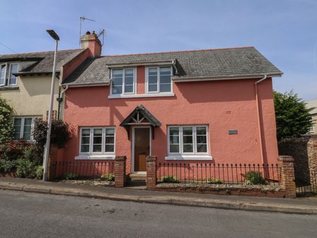 A house with a pink exterior and windows at 13 School Road Newton Abbot