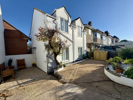 A house with a garden and driveway at Bohemian Beach Cottage in Bournemouth