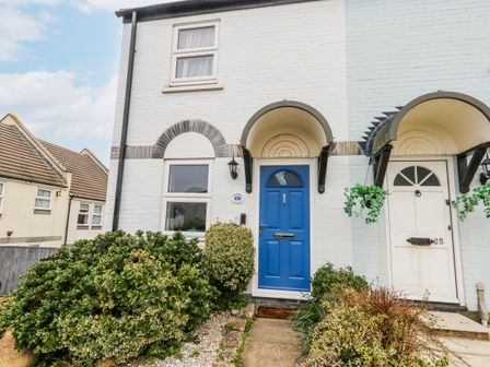 A front entrance with a blue door and window at 23 The Maltings in Weymouth