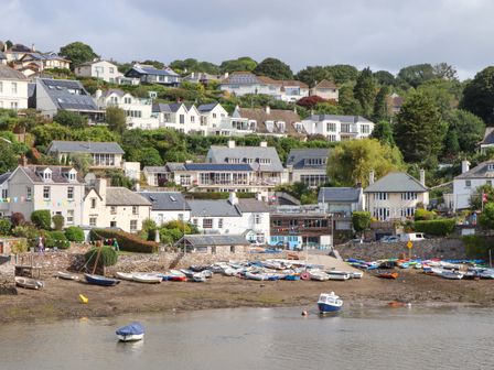 A coastal scene with houses and boats at The Porthole in Newton Ferrers