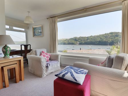 A living room with a view of the water at Kiln Cottage in Golant near Tywardreath