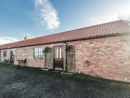 An exterior view of a brick building with doors and windows at Beck View