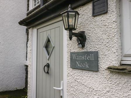 An entryway with a gray door and a house sign at Wansfell Nook in Ambleside