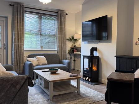 A living room with a sofa and coffee table at Ironstone Cottage in Eston