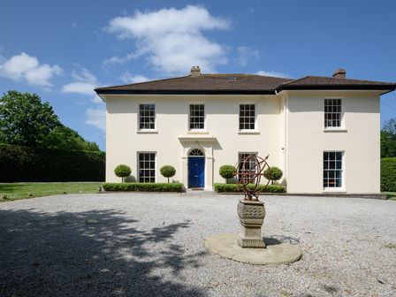A house with a garden and gravel driveway at The Old Vicarage in St Issey