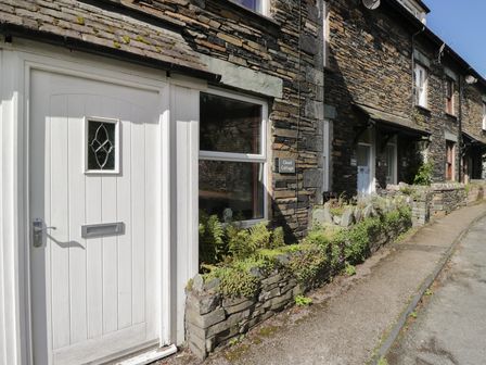 A door and window of Cloud Cottage in Ambleside