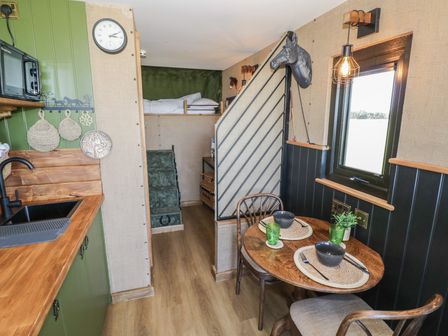 A kitchenette with dining table and chairs at GiGi's Horsebox Evesham