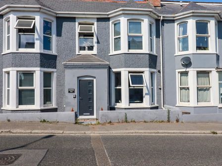 A house with multiple windows and a front door at Higher Tower Road