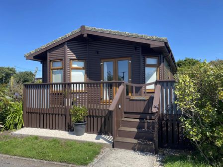 A house with a deck and railings at Lamorna in Sennen