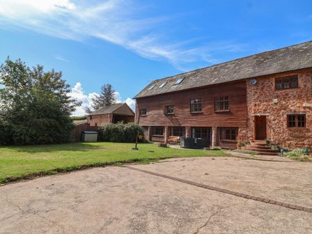 An outdoor view of a house and garden at Millbarn in Crowcombe