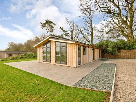 A house with large windows and a patio in Brayton, Aspatria