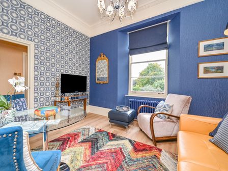 A living room with a television and sofa at Muntham Apartment 4 in Torquay