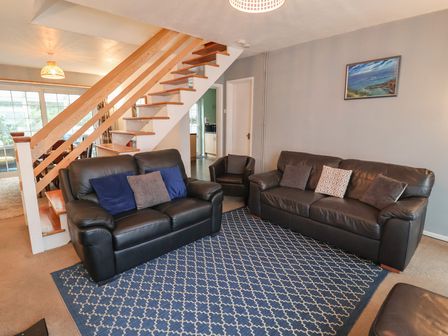 A living room with two sofas and an armchair at Cromer Holiday Home in Cromer
